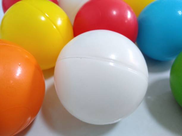 istock Colorful flying balls. Many multicolored balls flying over blue background 2162452725