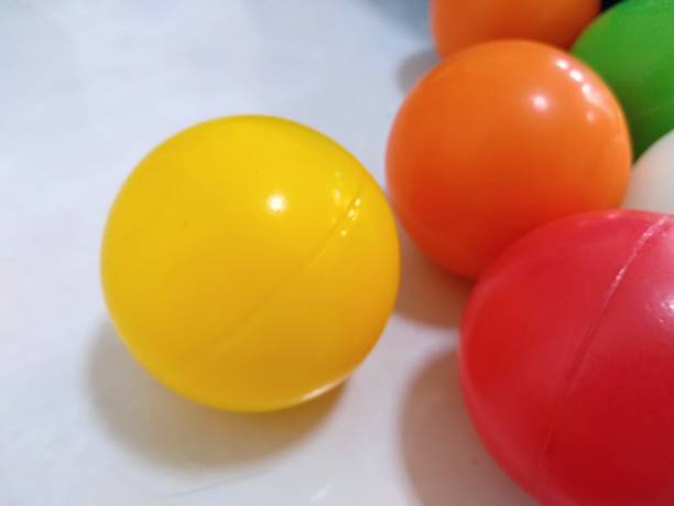 istock Colorful flying balls. Many multicolored balls flying over blue background 2162452726