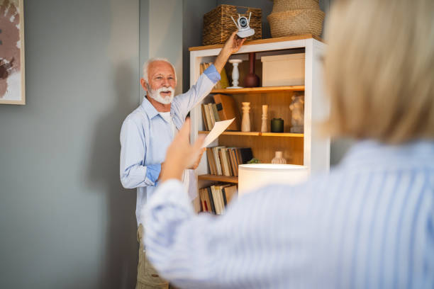 istock senior couple install and conect cctv security surveillance camera 2162454083