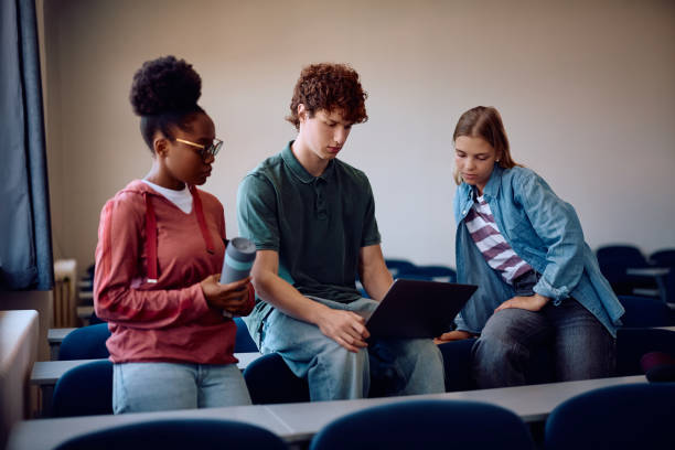 istock Multiracial group of college students using laptop in the classroom. 2162463071
