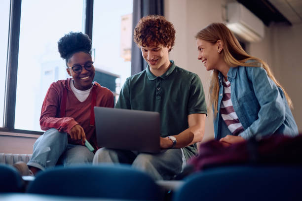istock Happy students e-learning on laptop in lecture hall at the university. 2162463075