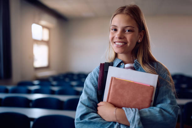 istock Happy female student in lecture hall at the university looking at camera. 2162463098