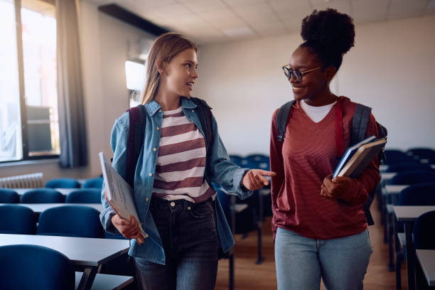 istock Female students talking while leaving the classroom after a lecture. 2162463099