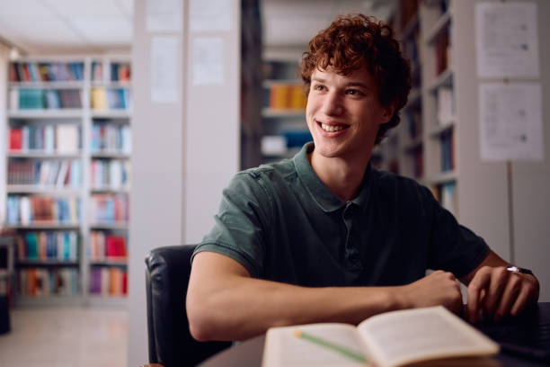 istock Portrait of happy student learning in library at the university. 2162463124