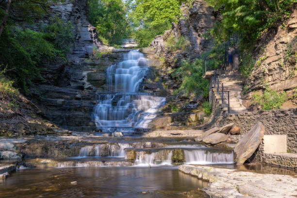 Beautiful cascading waterfall surrounded by lush greenery. Cascadilla Gorge in Ithaca New York- Finger Lakes Region