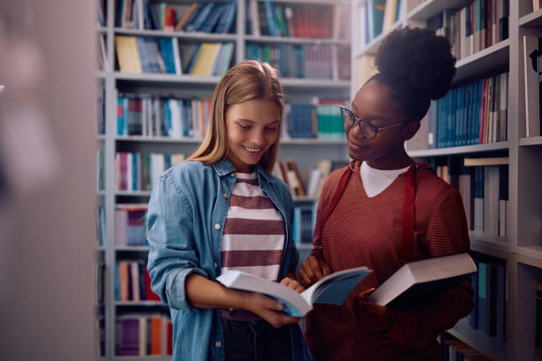 istock Happy female friends studying in library at the university. 2162463149