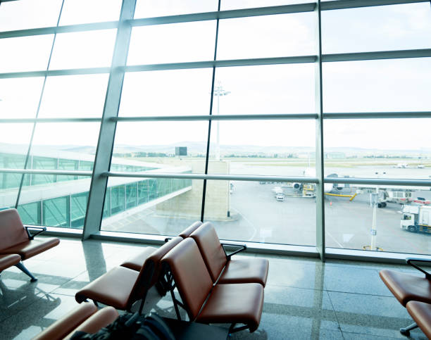 istock Empty airport terminal lounge with airplane on background 2162467730