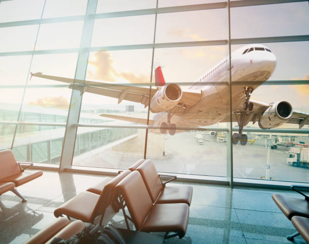 istock Empty airport terminal lounge with airplane on background 2162467732