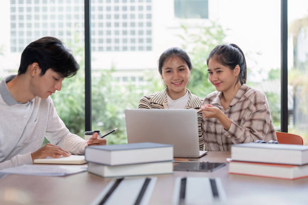 istock Group of Student Studying Together with Laptops and Books in a Modern Classroom Setting 2162473004