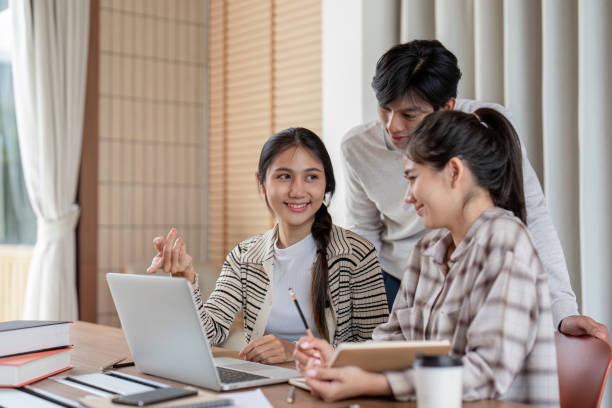 istock Group of Students Collaboration on a Project with Laptop in Modern Study Room 2162473328