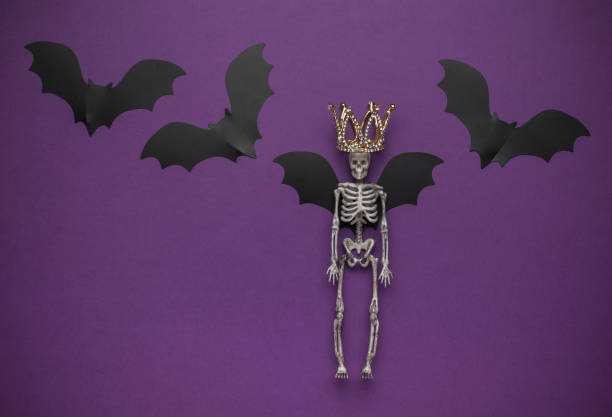 istock Skeleton with Crown and Bat Wings on Purple Background 2162475807