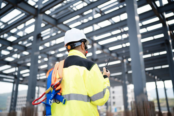 istock Middle-aged male construction technician wearing work helmet and protective workwear, working at a construction site 2162478977