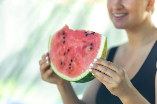 istock Funny woman eating watermelon on a picnic. 2162480109