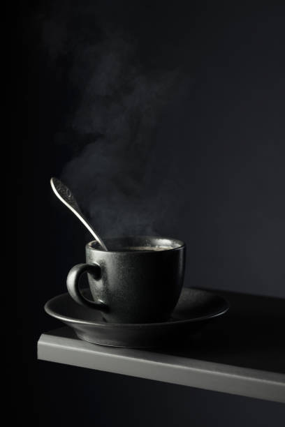 istock Black cup of coffee on a black background. 2162480167