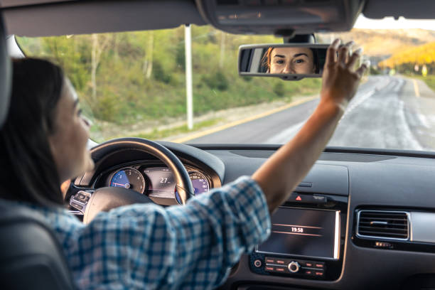 istock Attractive young woman driving a car, view from inside. 2162481212