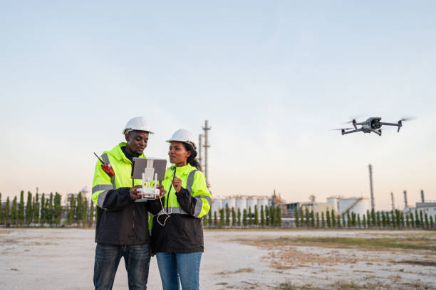 istock Team of Engineer Specialists Pilot Drone on Construction Site. 2162483115