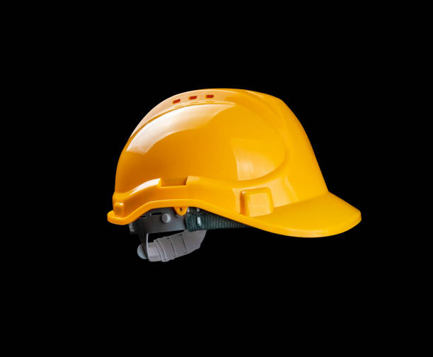 istock Yellow hard hat for construction workers. Protective clothing and accessories for employees. black background studio shot 2162485289