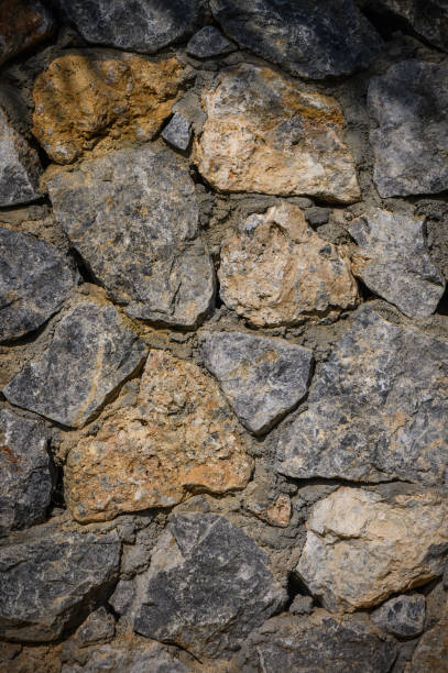 istock Stone wall texture. Decorative uneven cracked real stone wall surface. 3 2162486047