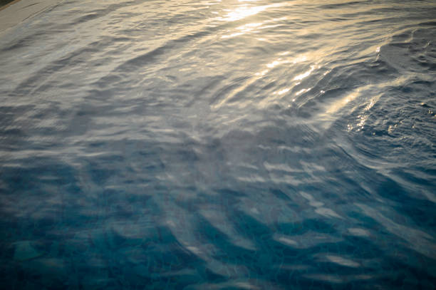 Ripple Water in swimming pool with sun reflection