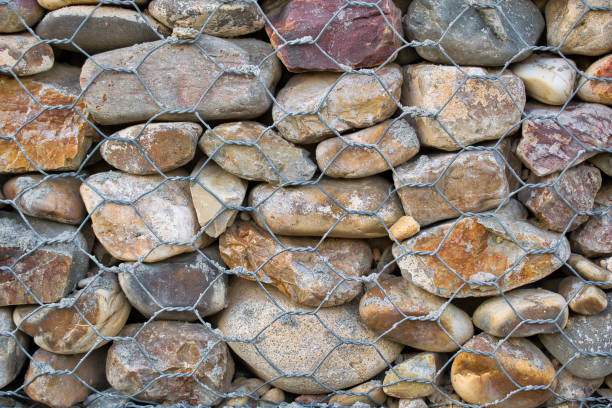 Wall of stones held with metal mesh.