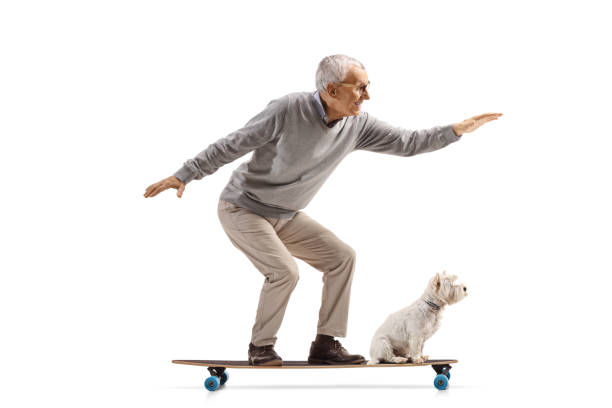 istock Elderly man and a dog riding on a longboard 2162488961