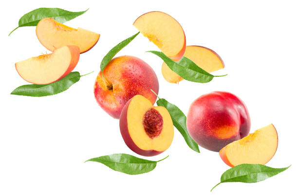 istock flying peach fruit with green leaf isolated on white background. clipping path 2162489375