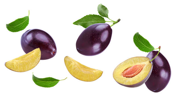 istock flying fresh plum fruit with green leaf and cut plum slices isolated on white background. clipping path 2162489417