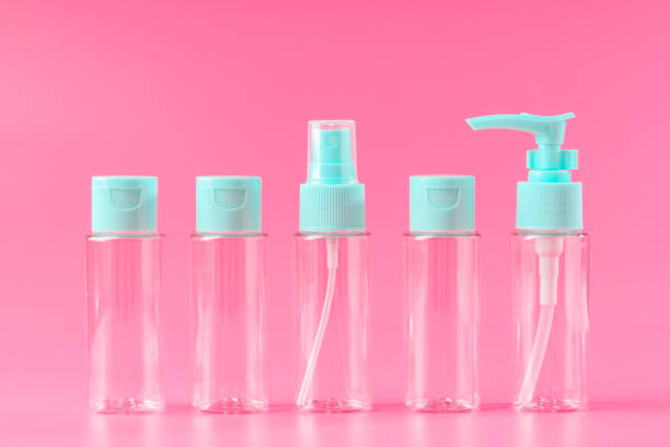 istock Five Empty Travel Bottles With Light Blue Caps on Pink Background 2162489629