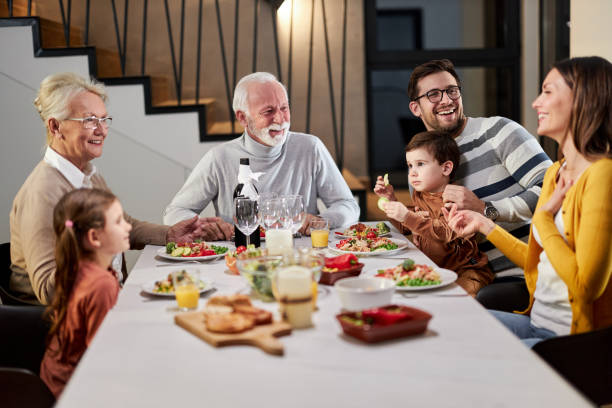 istock Happy extended family talking during lunch in dining room. 2162490461