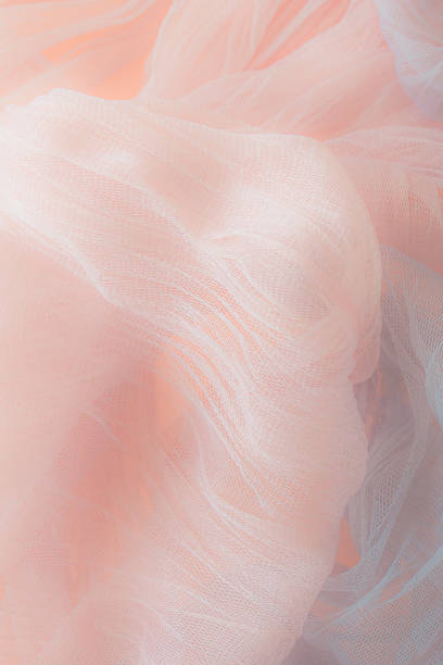 Gentle fabric background. Combination of pink and gray. Cold and warm. Colored tulle. Romantic wedding card. Love mood. Textile industry.