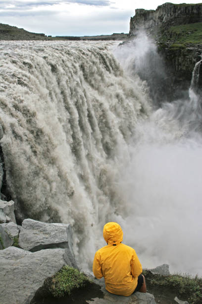 istock Tourist on a cliff looking at Dettifoss waterfall 2162491237