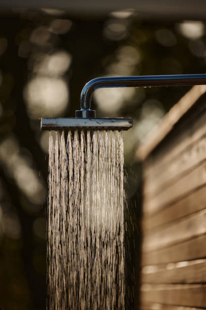 Close up of flowing water on an outdoor shower in the backyard.
