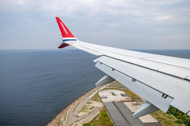 Copenhagen Airport, Denmark - June 8th 2024: Wing of a Boeing 737 Max 8 from Norwegian airlines approaching Copenhagen Airport- The plane is LN-FGF named Karin Boye after the famous Swedish writer