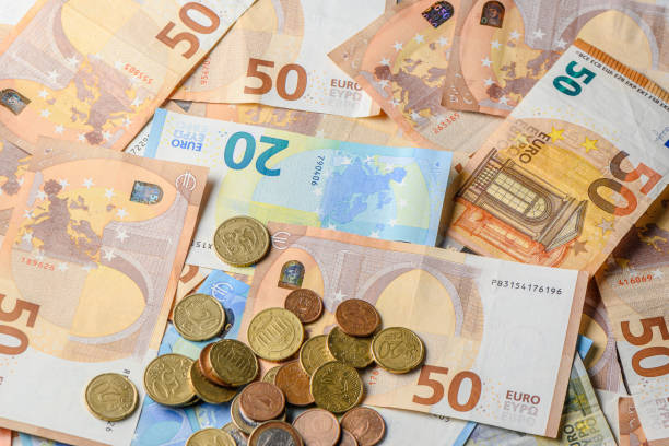 istock Euro bills and coins scattered on the table as a background 16 2162502187