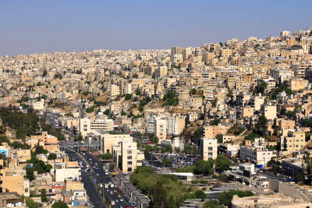 Amman in, Jordan - May 07 2024: Cityscape overlooking sandstone buildings and main roads in the afternoon