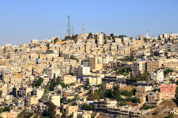 Amman in, Jordan - May 07 2024: Cityscape overlooking sandstone buildings and main roads in the afternoon