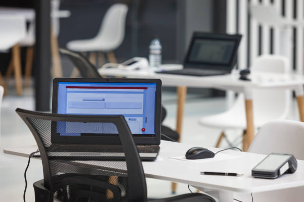 istock Coworking area with laptop tables and chairs. Workplace interior 2162505631