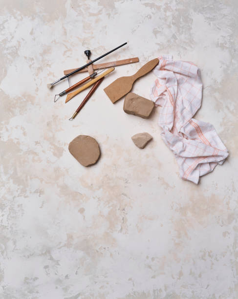 istock Making ceramic, women's hands and tools on the decorative table style background, up view. 2162505713