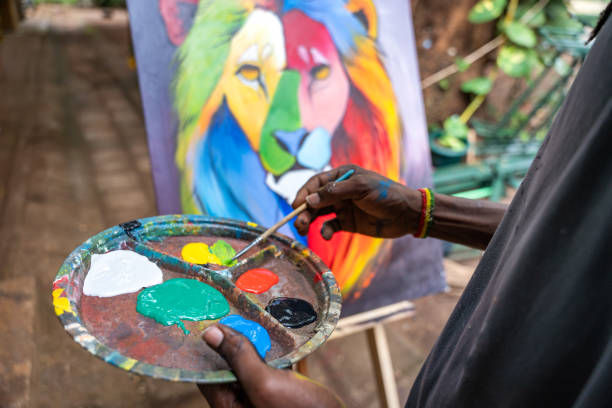 istock African painter using brush and palette to paint a picture 2162506060