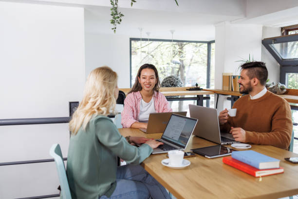 istock Relaxed and Productive Atmosphere. Colleagues talking in a shared office space. 2162506066