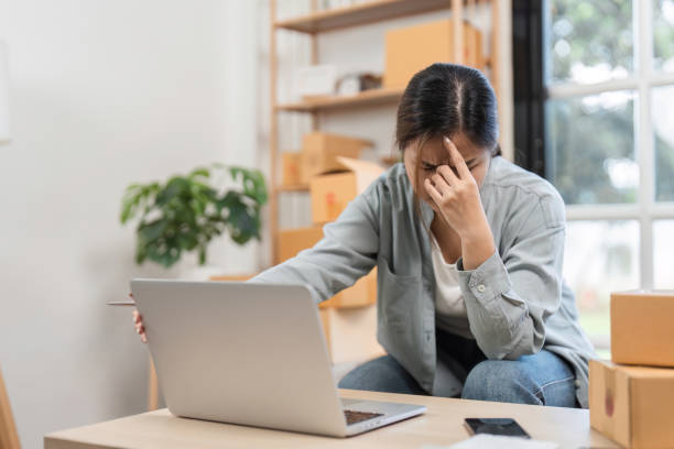 Young Woman Stressed About Online Sales System While Managing E-commerce Business from Home Office