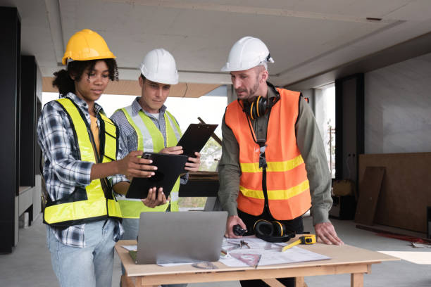 istock Engineering Team Collaborates on Work Plan in Modern Construction Site with Safety Gear and Equipment 2162507714
