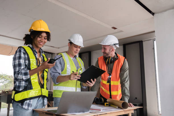 istock Engineering Team Collaborates on Work Plan at Construction Site with Safety Gear and Equipment 2162507827