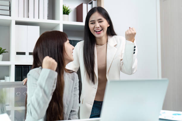istock Successful Business Collaboration Between Two Women Celebrating Achievement in Modern Office Environment 2162508193