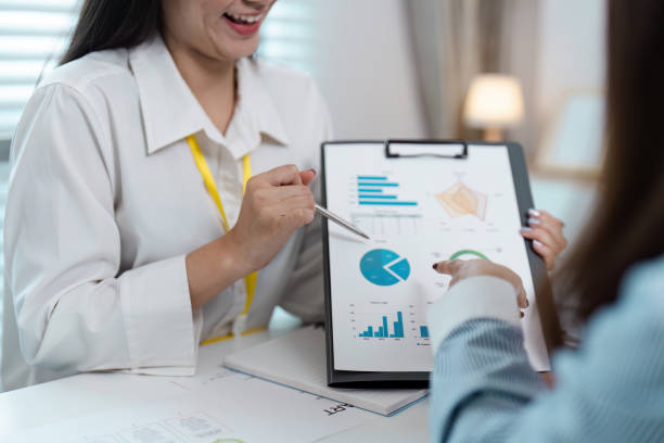 istock Business Meeting with Colleagues Analyzing Financial Reports and Data Charts in a Modern Office Setting 2162508478
