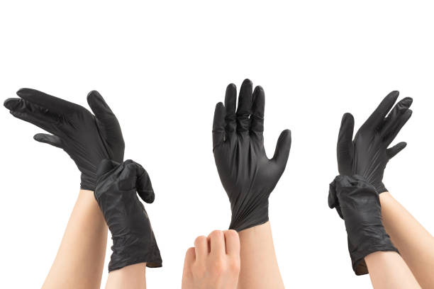 istock Woman puts on black rubber gloves. 2162510619