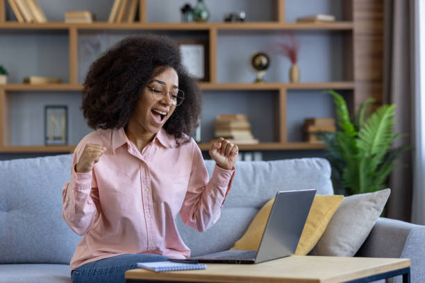istock Excited woman celebrating success while working from home on a laptop 2162513521