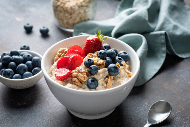 istock Breakfast oatmeal bowl with blueberries, strawberry and walnuts 2162516448
