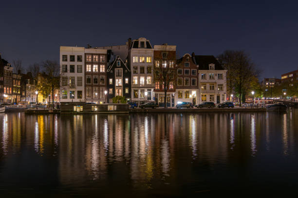 Amsterdam in the night, with the city lights and the reflections in the cansl water