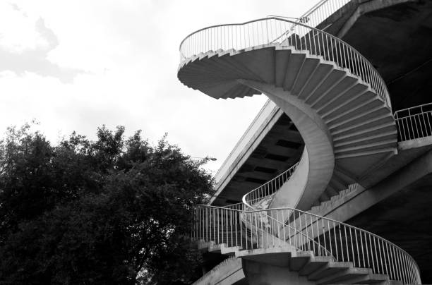 Minimalist staircase going up to the light in a dark room